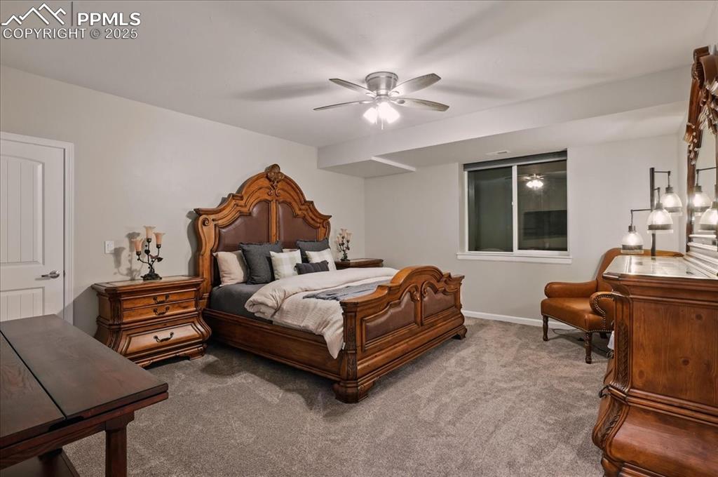 11970 Silver Concho Trail Elbert, CO 80106 - Photo 29 of 44 a bedroom with a bed and wooden floor