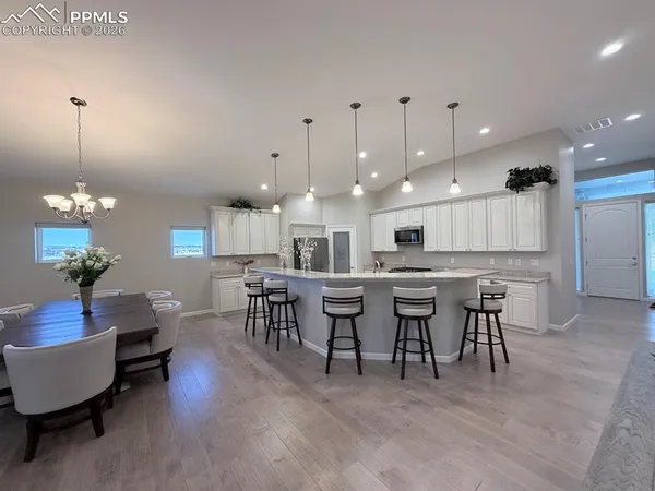a large kitchen with a table and chairs