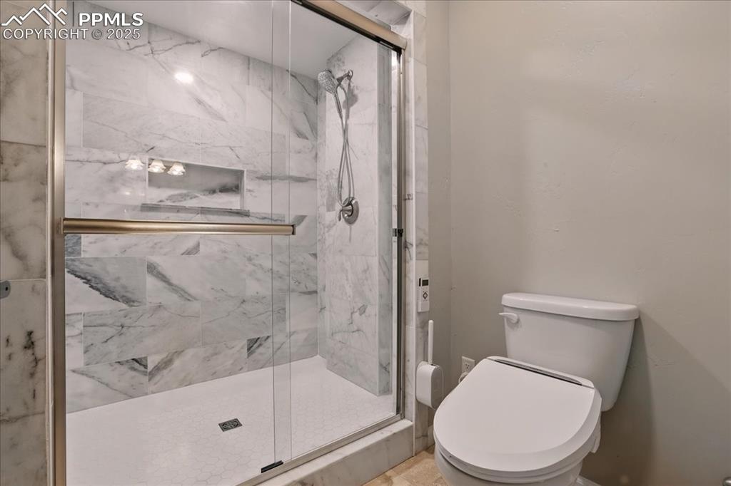 11970 Silver Concho Trail Elbert, CO 80106 - Photo 32 of 44 a white toilet next to a bathroom