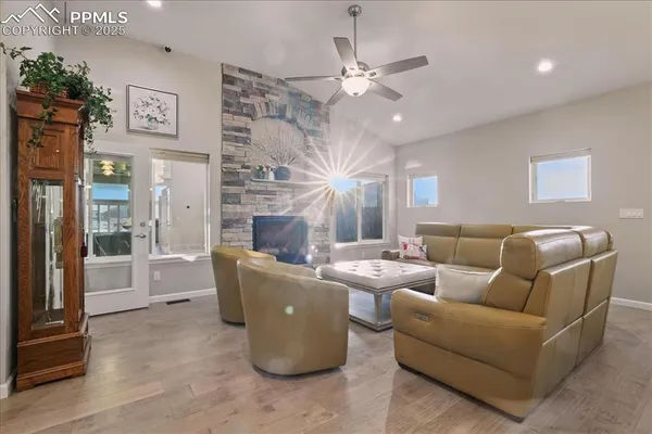 a living room with furniture a large window and a fireplace
