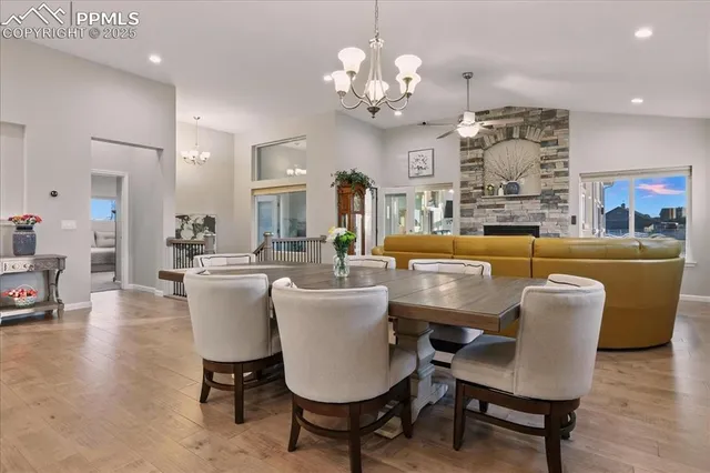a view of a dining room with furniture a chandelier and wooden floor