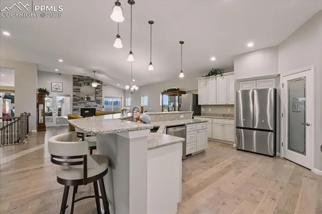 a kitchen with stainless steel appliances kitchen island a refrigerator and a stove