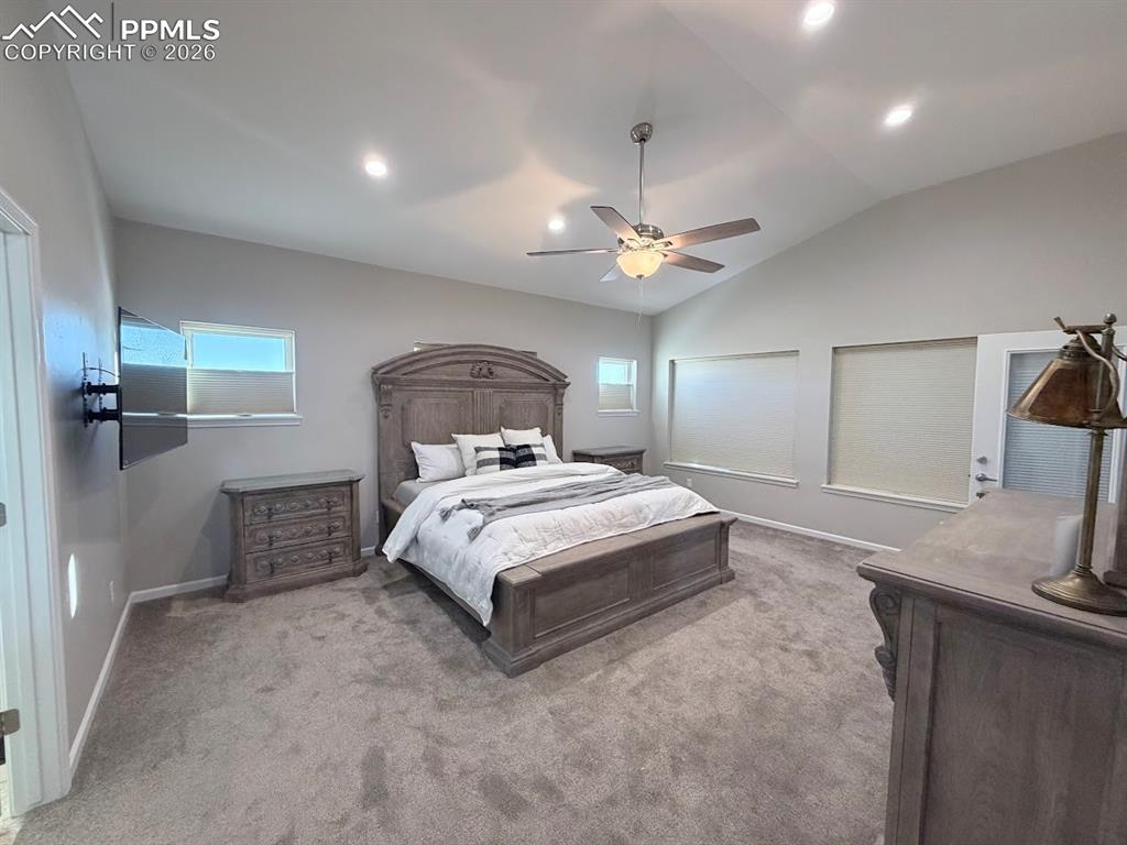 11970 Silver Concho Trail Elbert, CO 80106 - Photo 8 of 44 a bedroom with a large bed and ceiling fan