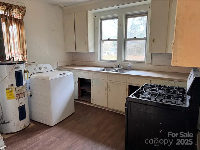 a kitchen with a sink stove and cabinets