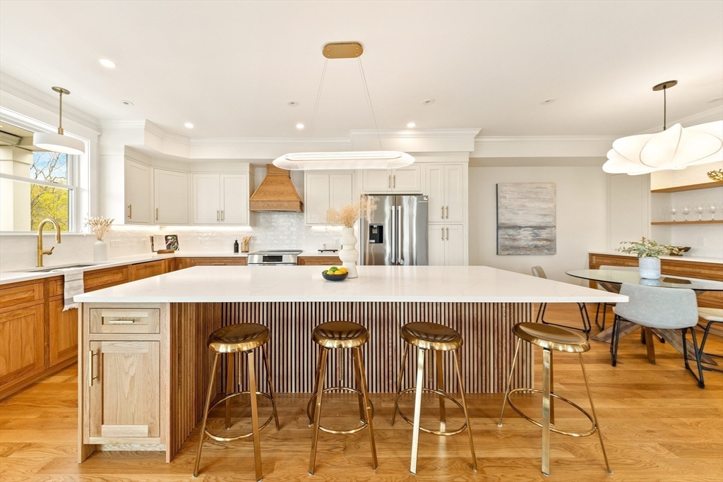 3 Colburn Street, Unit 1 Gloucester, MA 01930 - Photo 18 of 42 a view of a kitchen with kitchen island a dining table and chairs