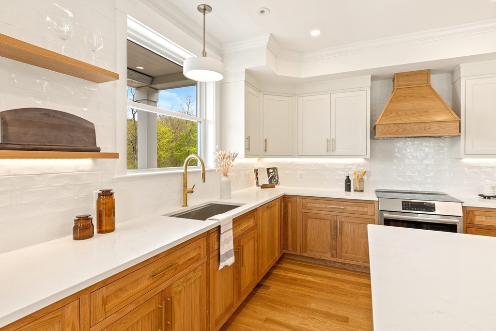 3 Colburn Street, Unit 1 Gloucester, MA 01930 - Photo 20 of 42 a kitchen with a sink a counter top space cabinets and stainless steel appliances