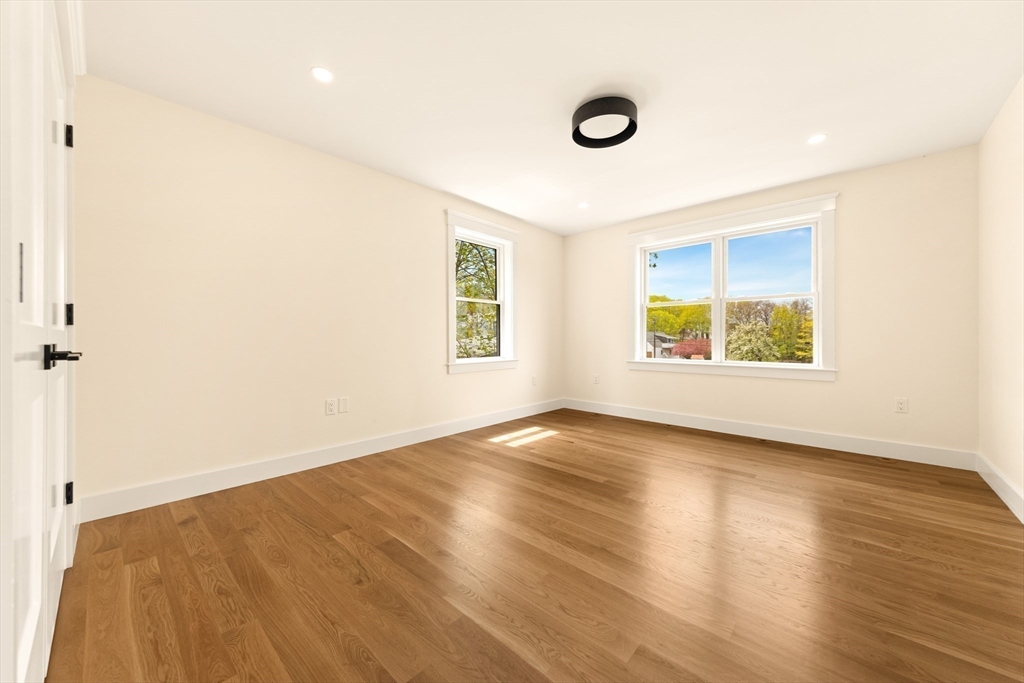 3 Colburn Street, Unit 1 Gloucester, MA 01930 - Photo 29 of 42 an empty room with wooden floor and windows