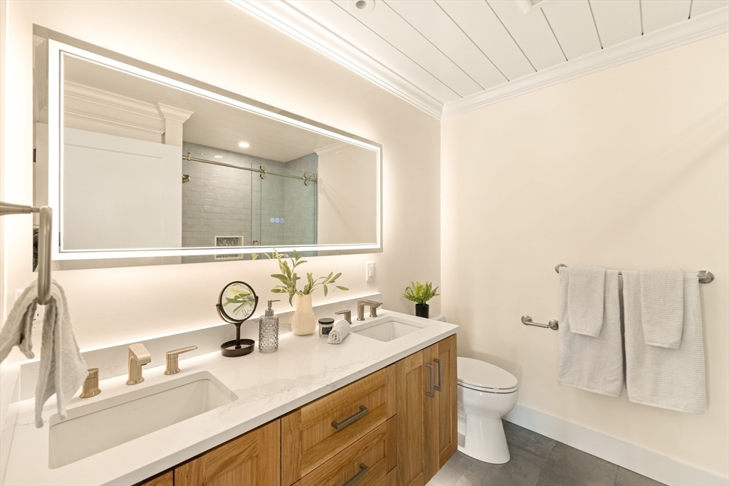 3 Colburn Street, Unit 1 Gloucester, MA 01930 - Photo 30 of 42 a bathroom with a double vanity sink mirror and toilet
