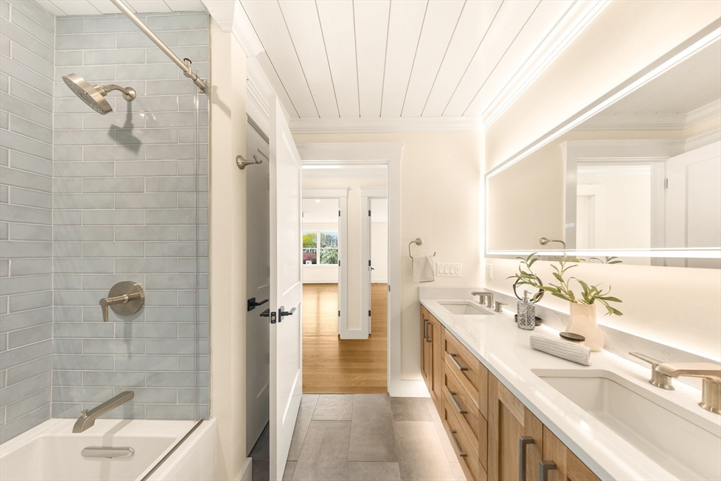 3 Colburn Street, Unit 1 Gloucester, MA 01930 - Photo 32 of 42 a bathroom with a double vanity sink a toilet and shower