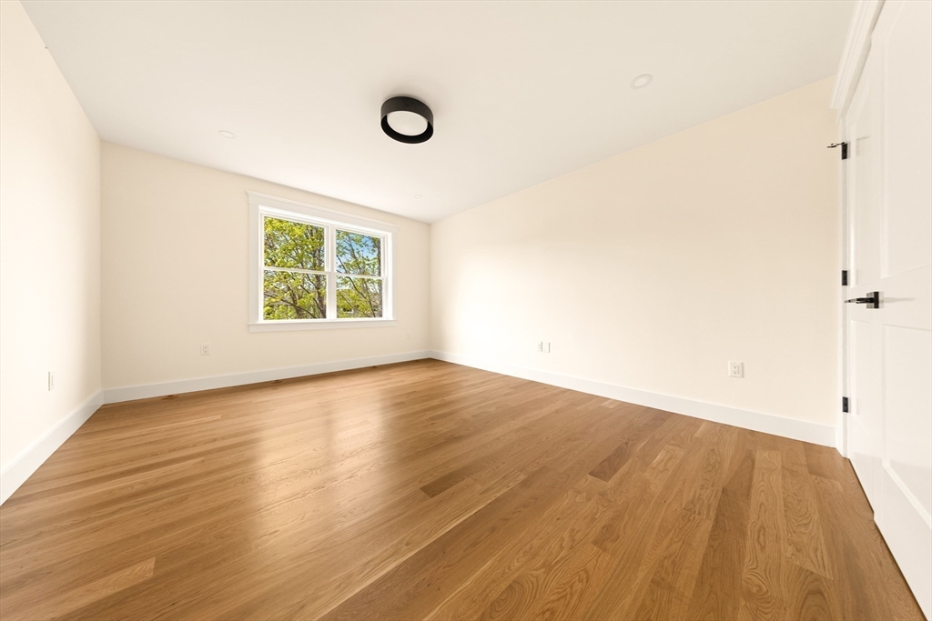 3 Colburn Street, Unit 1 Gloucester, MA 01930 - Photo 33 of 42 an empty room with wooden floor and windows