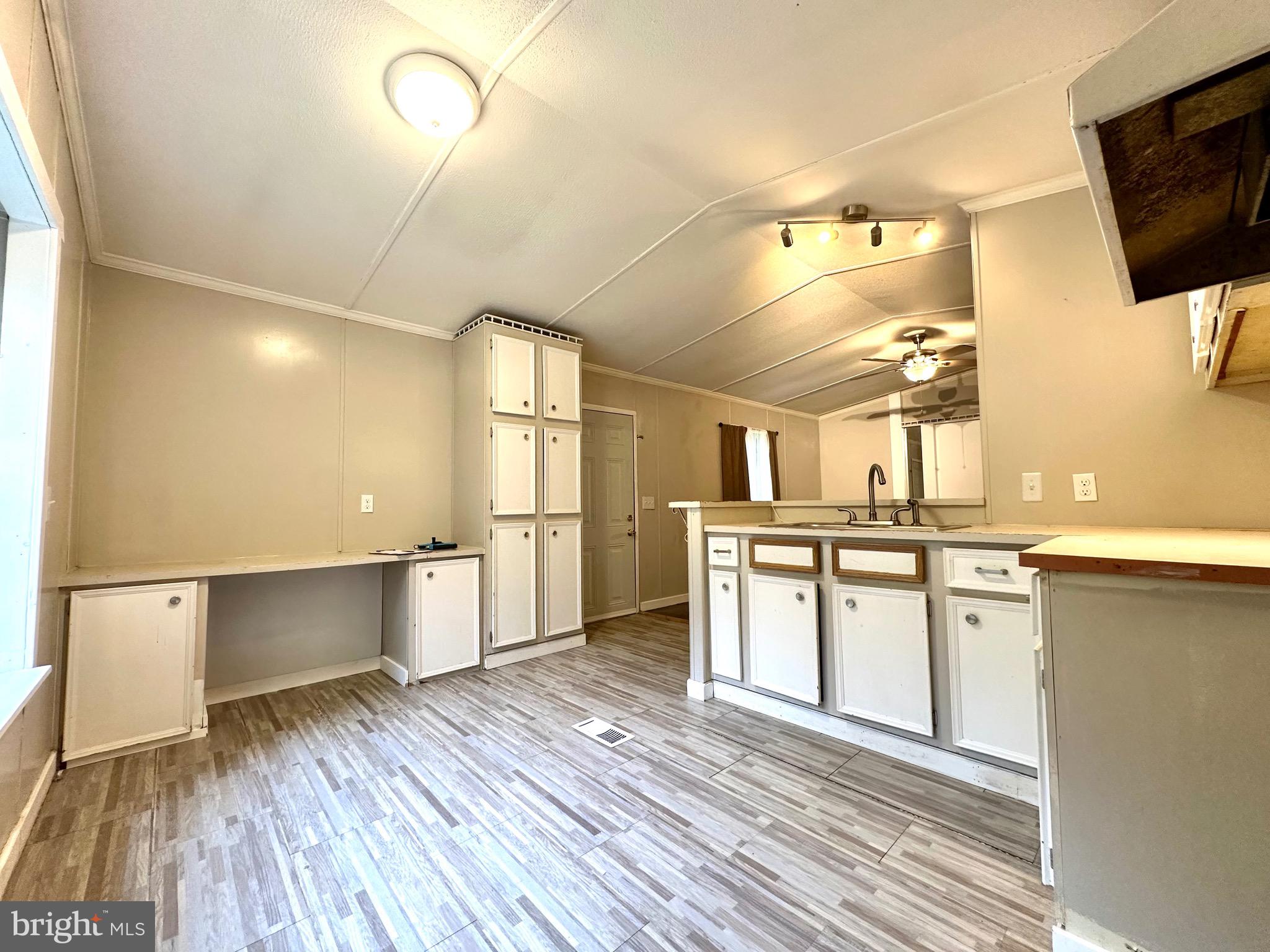 606 Dogwood Acres Road Bumpass, VA 23024 - Photo 6 of 20 a kitchen with stainless steel appliances wooden floors and large window