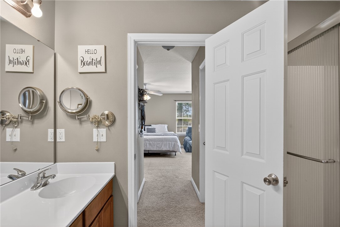 151 Towne Creek Trail Anderson, SC 29621 - Photo 20 of 49 A well-appointed vanity with a large mirror and an adjacent primary bedroom create a harmonious space.