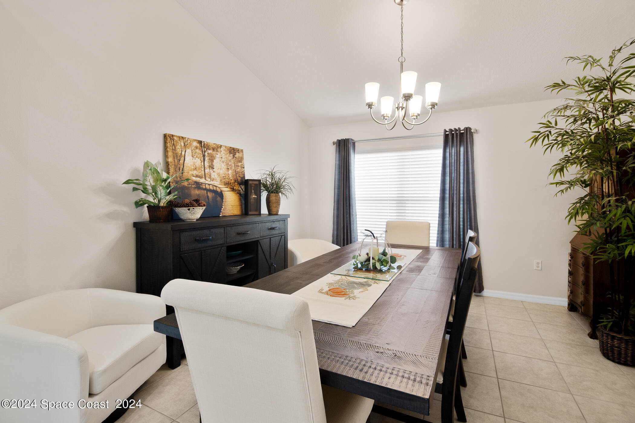 3412 Siderwheel Drive Rockledge, FL 32955 - Photo 12 of 39 a view of a dining room with furniture and a potted plant