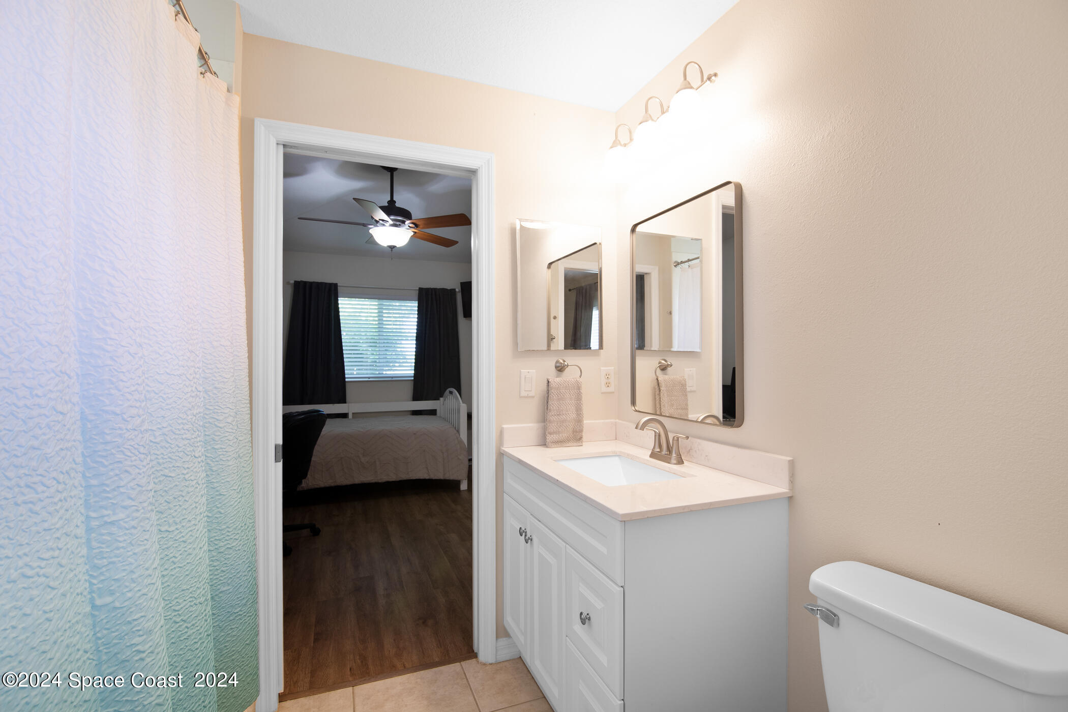 3412 Siderwheel Drive Rockledge, FL 32955 - Photo 23 of 39 a en suite bathroom with a double vanity sink and a mirror