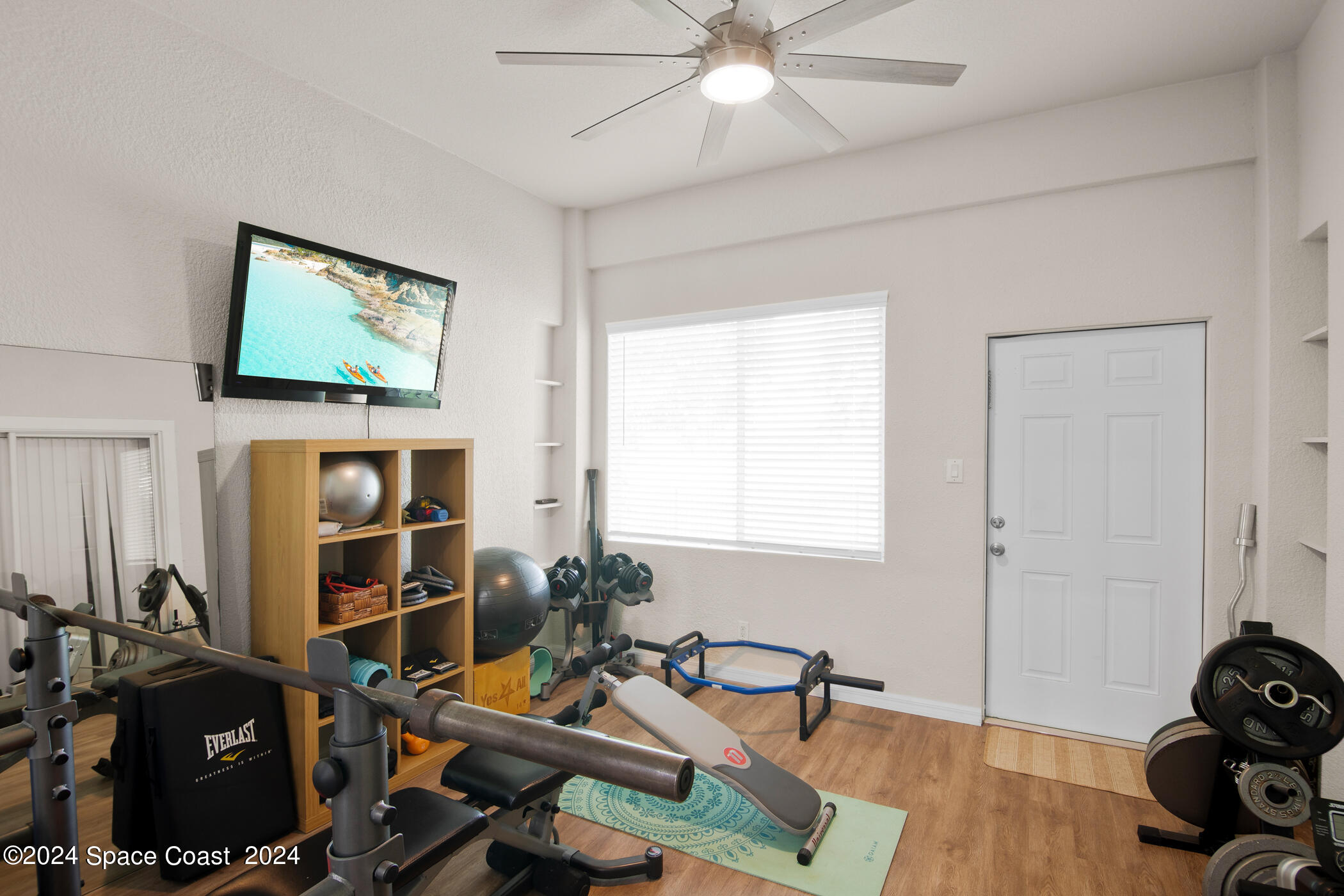 3412 Siderwheel Drive Rockledge, FL 32955 - Photo 27 of 39 a room with gym equipment and a flat screen tv