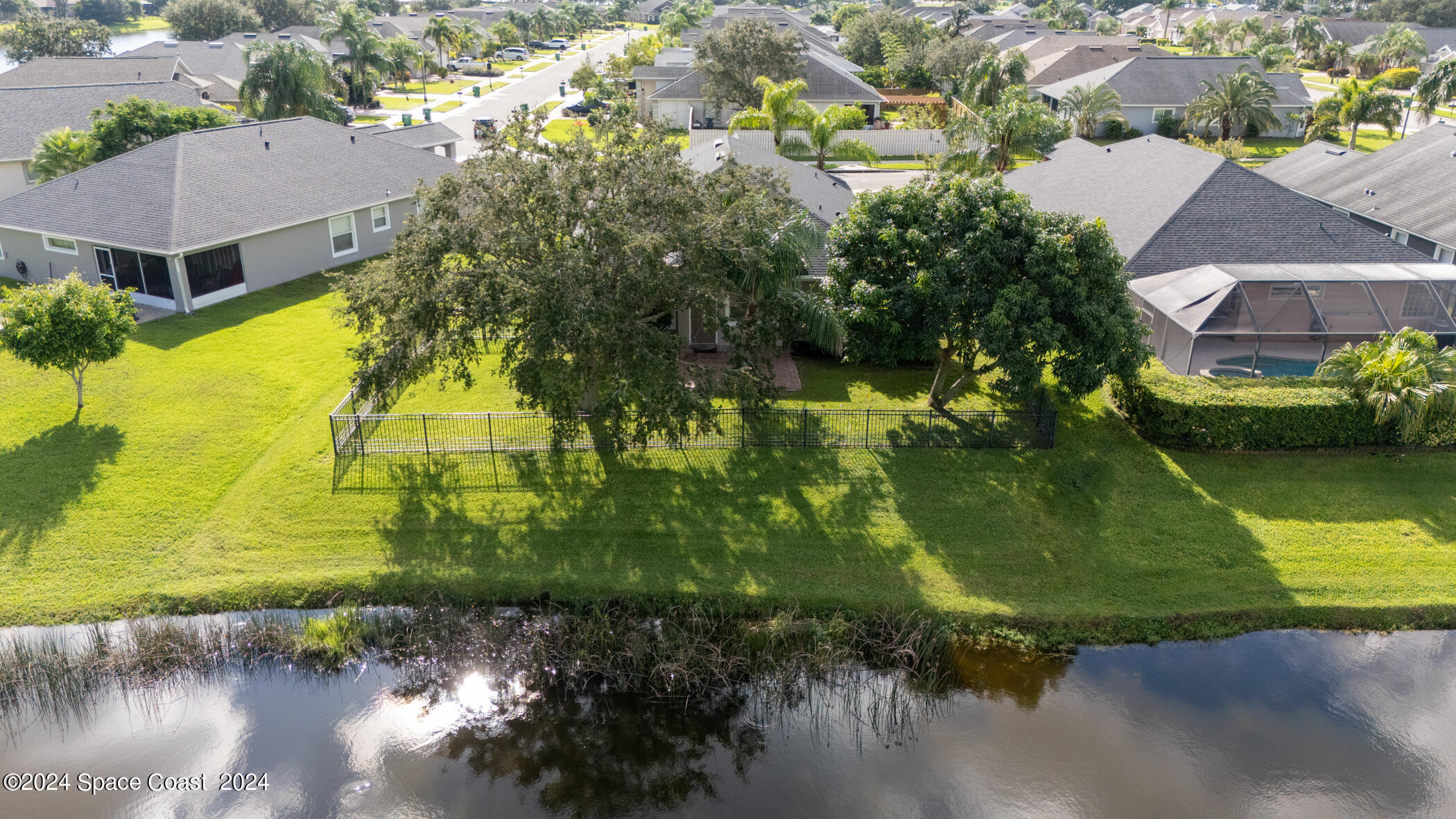 3412 Siderwheel Drive Rockledge, FL 32955 - Photo 9 of 39 an aerial view of a house with a yard and lake view
