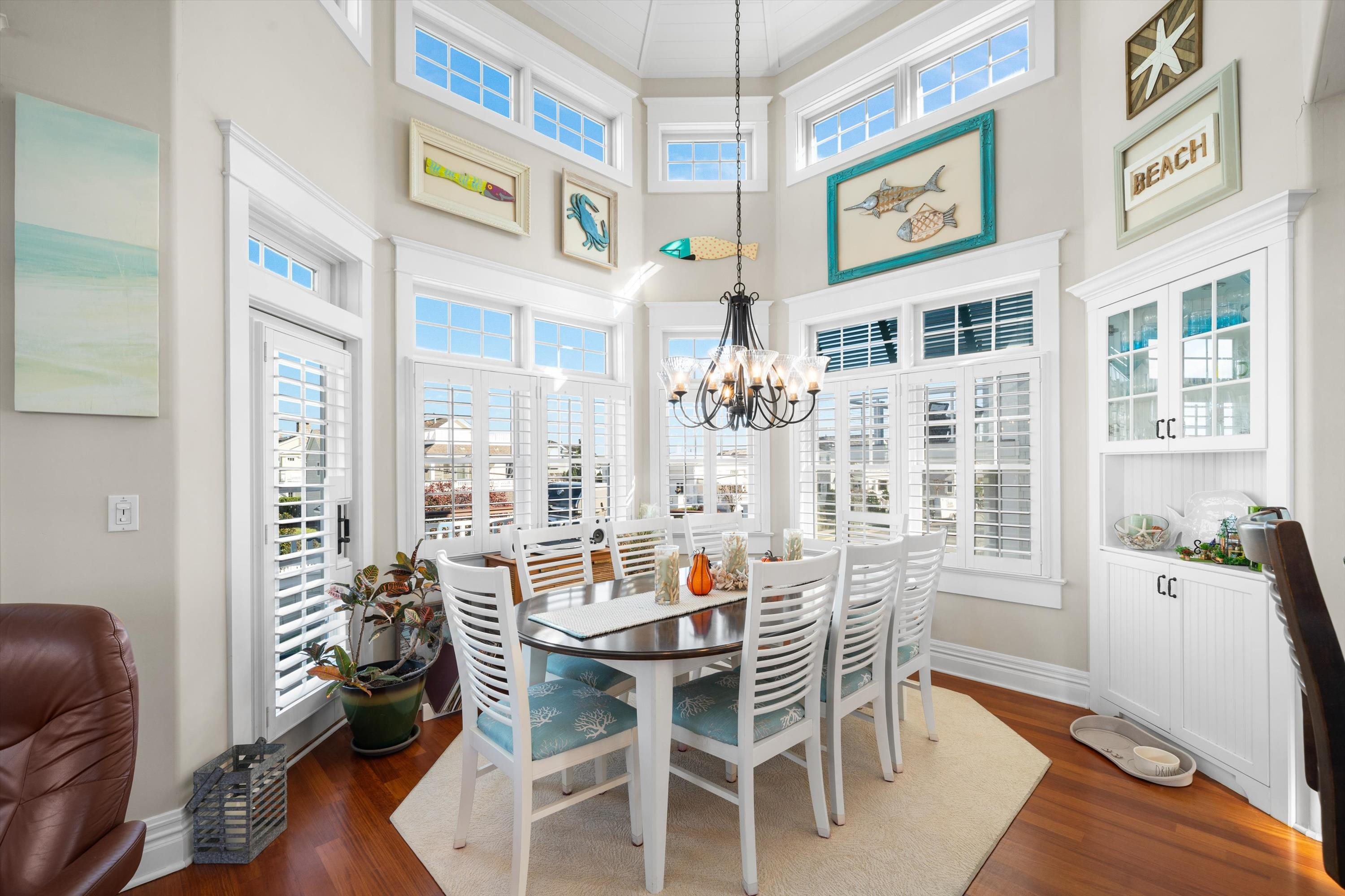 8600 2nd Stone Harbor, NJ 08247 - Photo 11 of 45 a dining room with furniture a floor to ceiling window and wooden floor