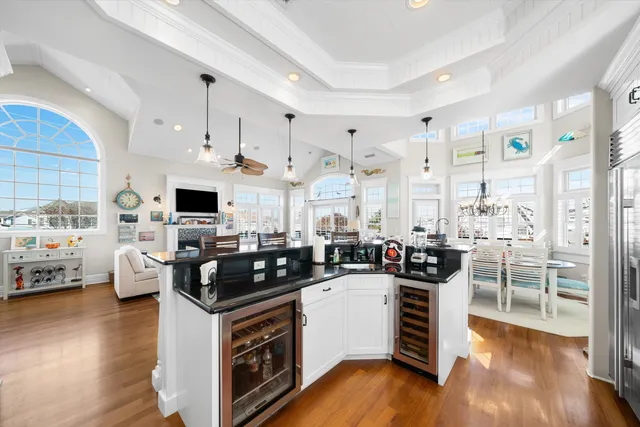 a kitchen with stainless steel appliances a stove a sink a refrigerator cabinets and wooden floor