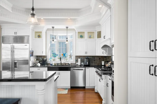 a kitchen with stainless steel appliances granite countertop a sink and cabinets