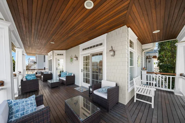 a balcony with furniture and wooden floor