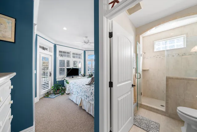 a bathroom with a granite countertop sink a toilet and shower