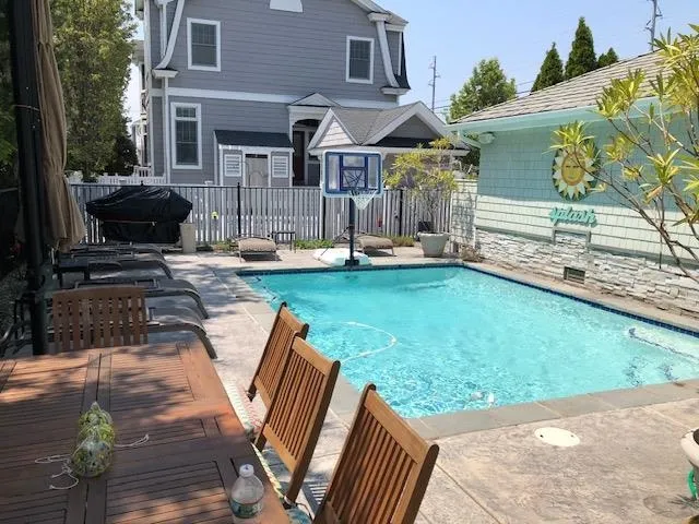 a view of a house with backyard and sitting area