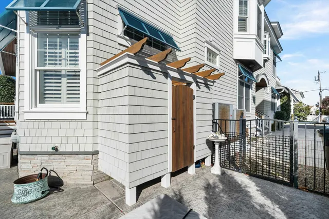a view of a house with a patio and a yard