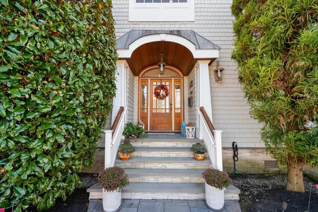 a front view of a house with a garden