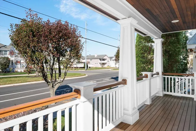 a view of a porch with wooden floor and fence