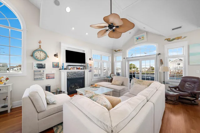 a living room with furniture a fireplace and a flat screen tv