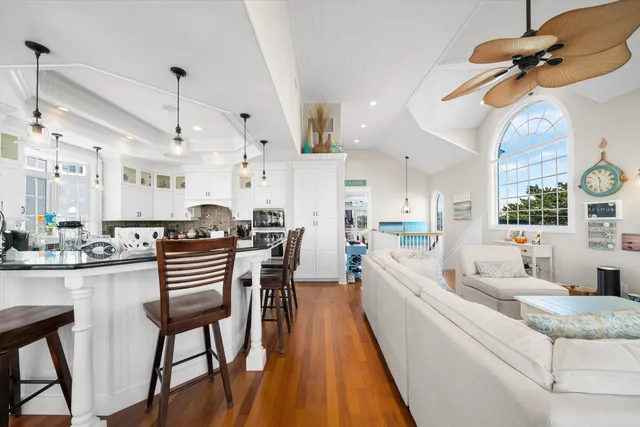 a large kitchen with a table and chairs