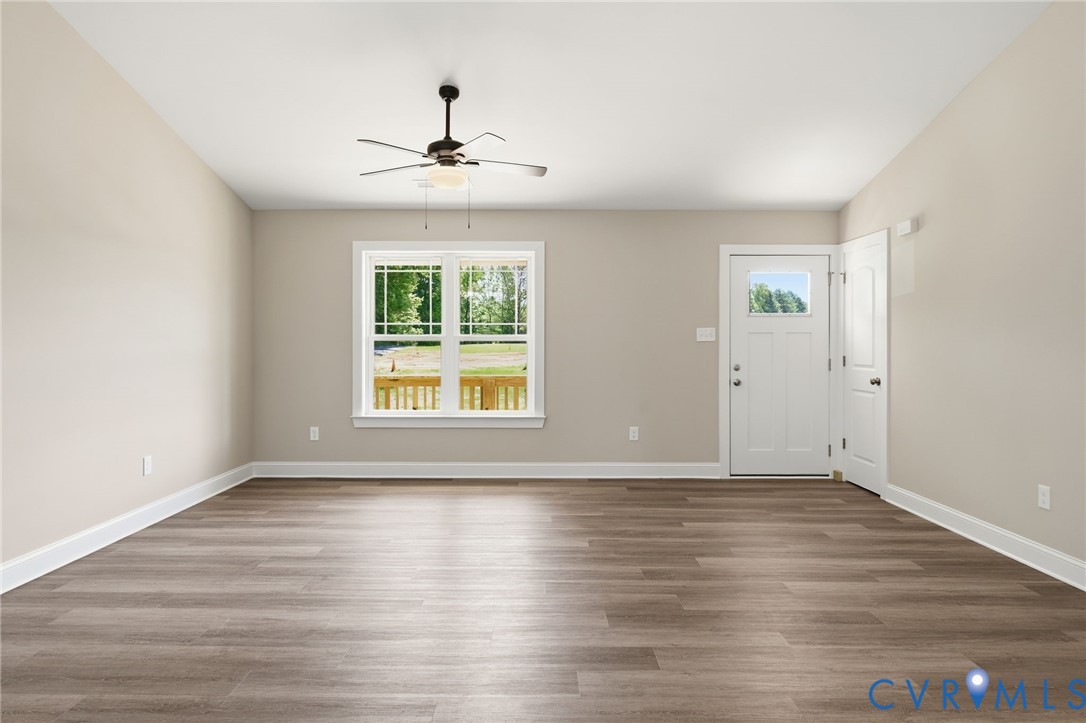17557 Hewlett Road Beaverdam, VA 23015 - Photo 4 of 29 a view of an empty room with wooden floor and a window
