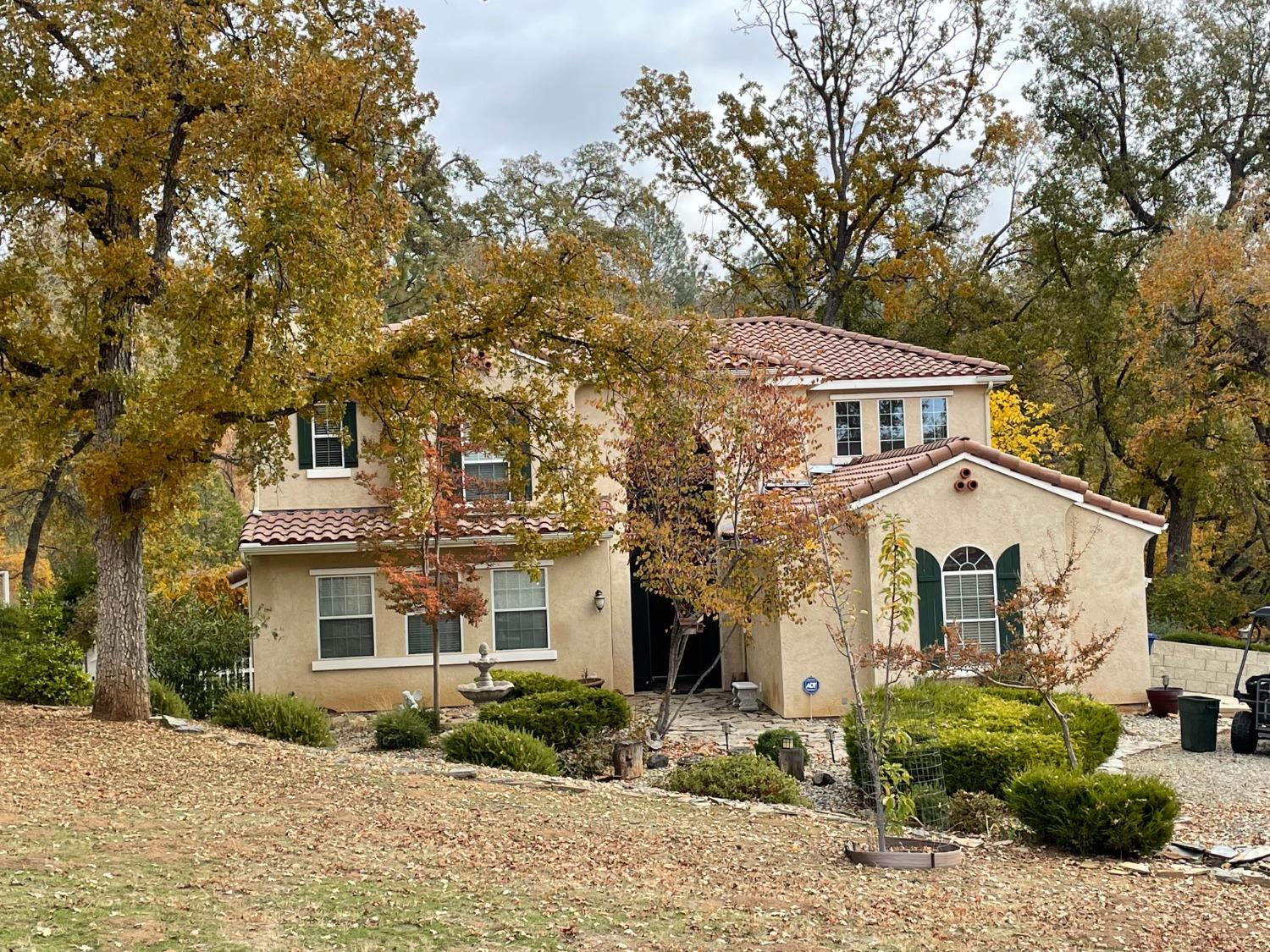 34811 Wintergreen Loop North Fork, CA 93643 - Photo 1 of 18 a front view of a house with garden