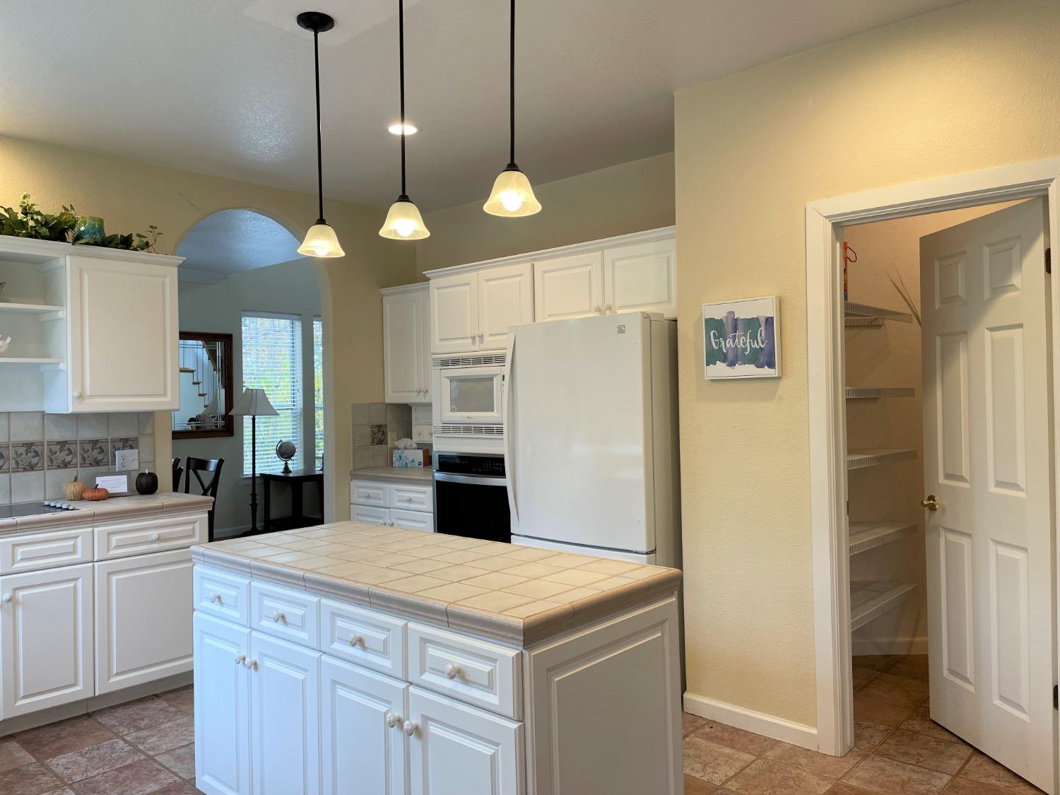 34811 Wintergreen Loop North Fork, CA 93643 - Photo 8 of 18 a kitchen with a refrigerator a sink and cabinets