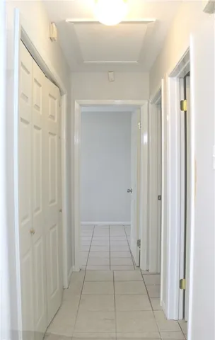 a view of a hallway to rooms
