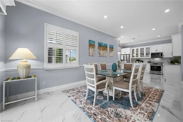 a dining room with furniture and window