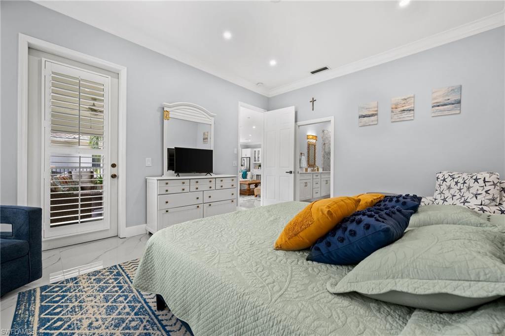 5010 Marina Cove Drive, Unit 4 Naples, FL 34112 - Photo 16 of 42 a bedroom with a large bed and a flat screen tv