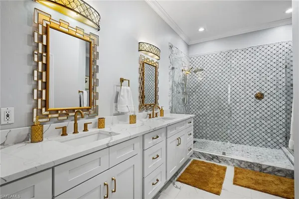 a bathroom with a double vanity sink mirror and shower