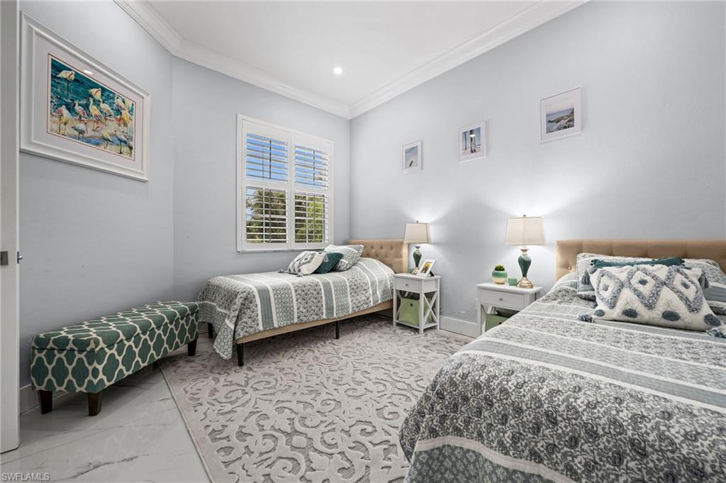 5010 Marina Cove Drive, Unit 4 Naples, FL 34112 - Photo 21 of 42 a bedroom with a bed and a couch