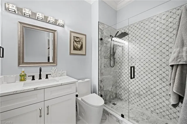 a bathroom with a toilet sink and shower