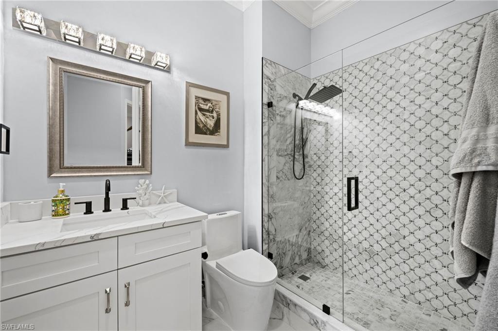 5010 Marina Cove Drive, Unit 4 Naples, FL 34112 - Photo 24 of 42 a bathroom with a toilet sink and shower