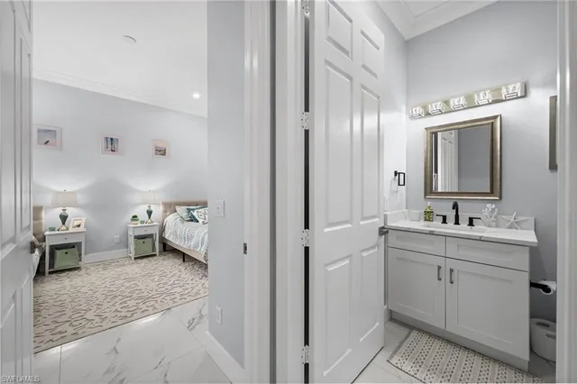 a en suite bathroom with a granite countertop sink mirror and toilet