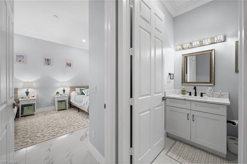 5010 Marina Cove Drive, Unit 4 Naples, FL 34112 - Photo 25 of 42 a en suite bathroom with a granite countertop sink mirror and toilet