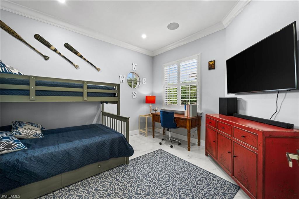 5010 Marina Cove Drive, Unit 4 Naples, FL 34112 - Photo 26 of 42 a living room with furniture and a flat screen tv