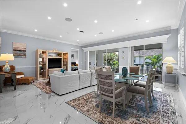 a living room with furniture a flat screen tv and a large window