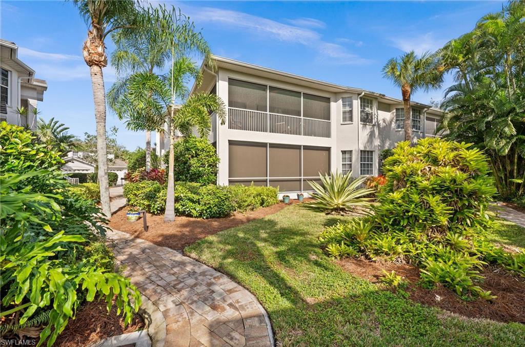 5010 Marina Cove Drive, Unit 4 Naples, FL 34112 - Photo 32 of 42 a front view of a house with a yard