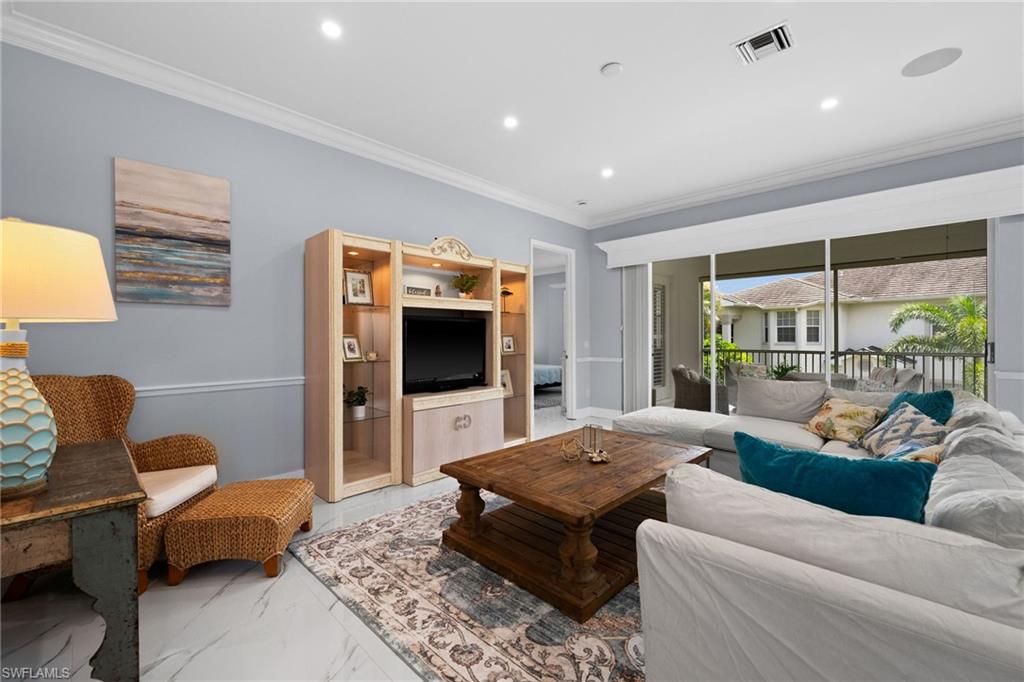 5010 Marina Cove Drive, Unit 4 Naples, FL 34112 - Photo 4 of 42 a living room with furniture and a flat screen tv