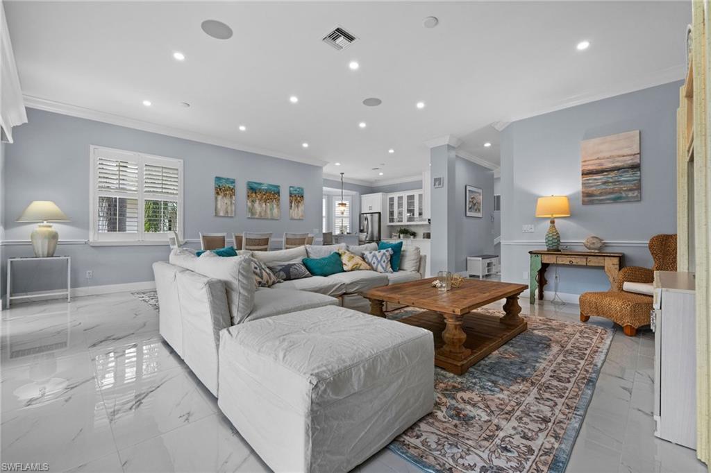 5010 Marina Cove Drive, Unit 4 Naples, FL 34112 - Photo 6 of 42 a living room with furniture and a table