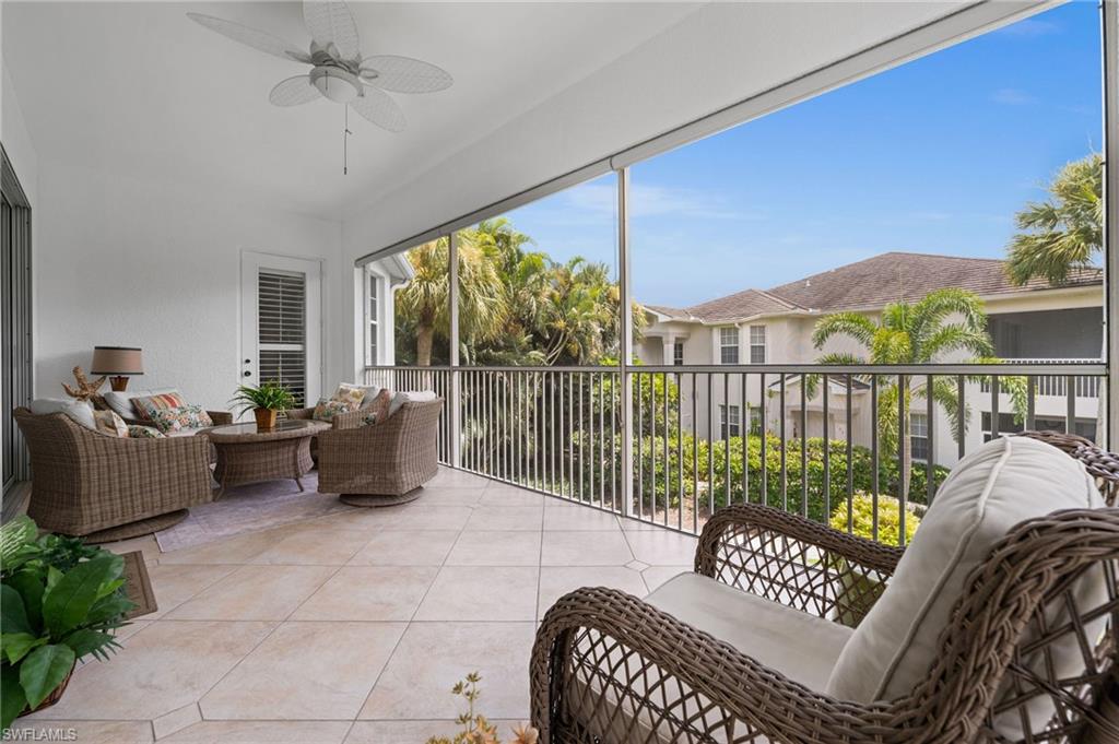 5010 Marina Cove Drive, Unit 4 Naples, FL 34112 - Photo 8 of 42 a living room with furniture and a floor to ceiling window
