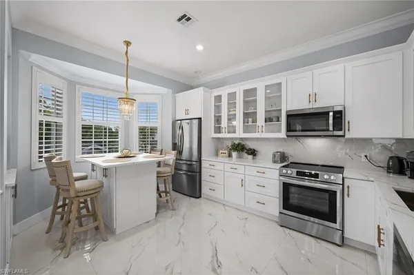 a kitchen with a stove a sink and microwave